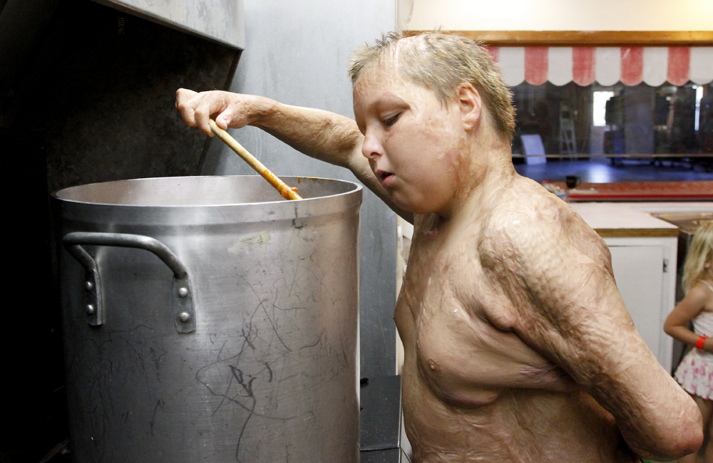 Austin Souder, 13, of Odessa, Texas, peers into a large pot of chili ...